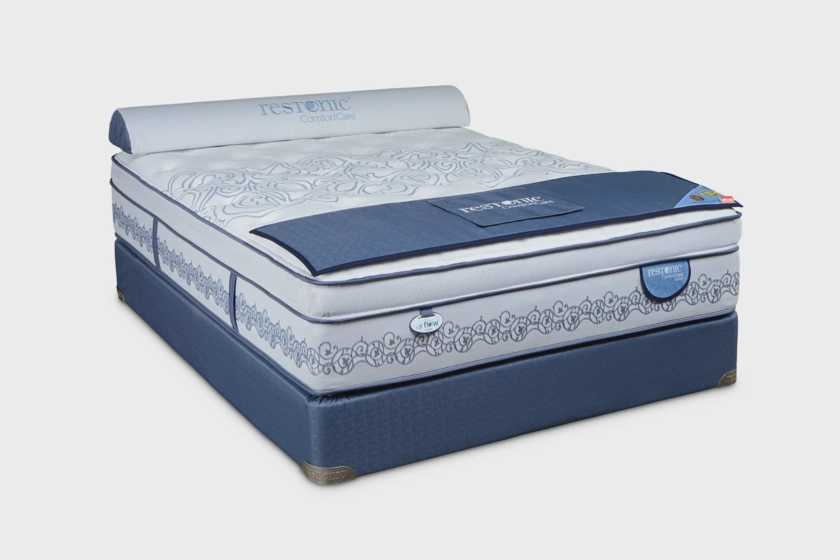 Restonic ComfortCare mattress styled in a neutral bedroom