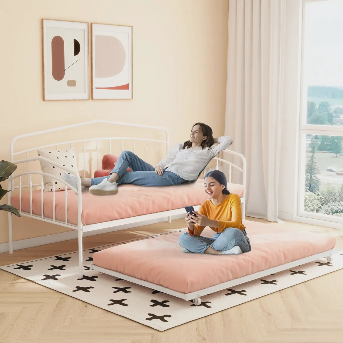 White metal twin daybed with a pull-out trundle in a guest room
