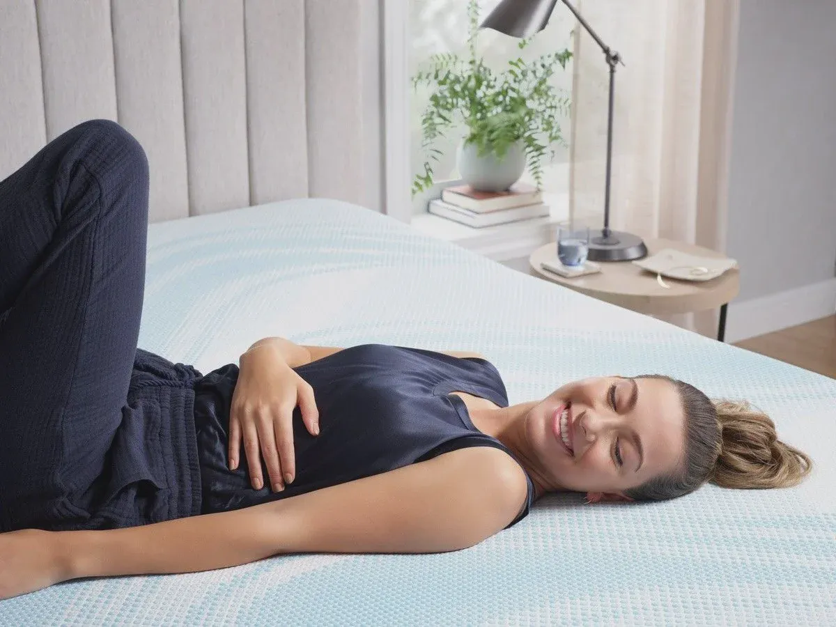 TEMPUR-LuxeBreeze hybrid mattress shown undressed in a bedroom