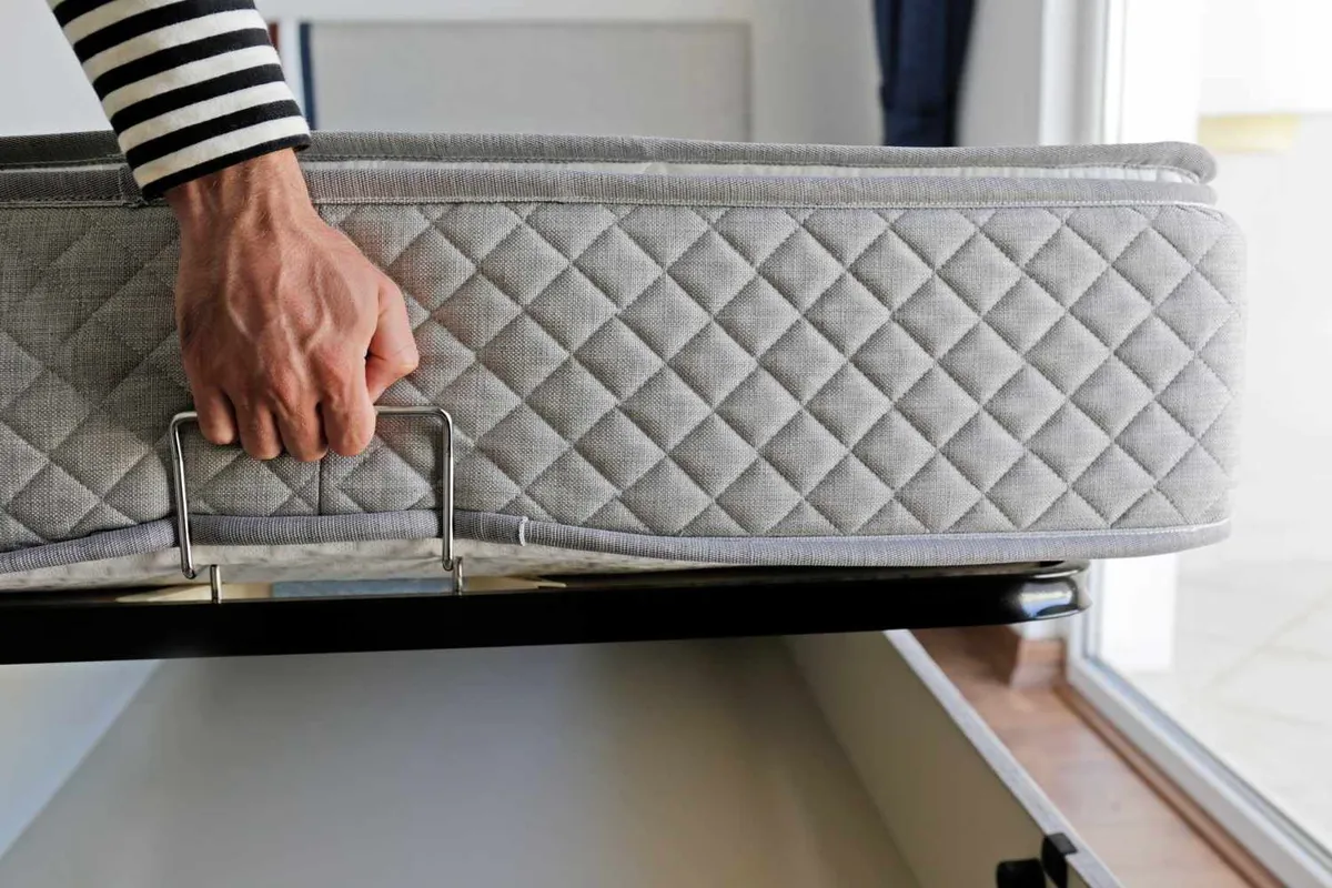 A mattress stored in a clean, dry indoor space away from humidity