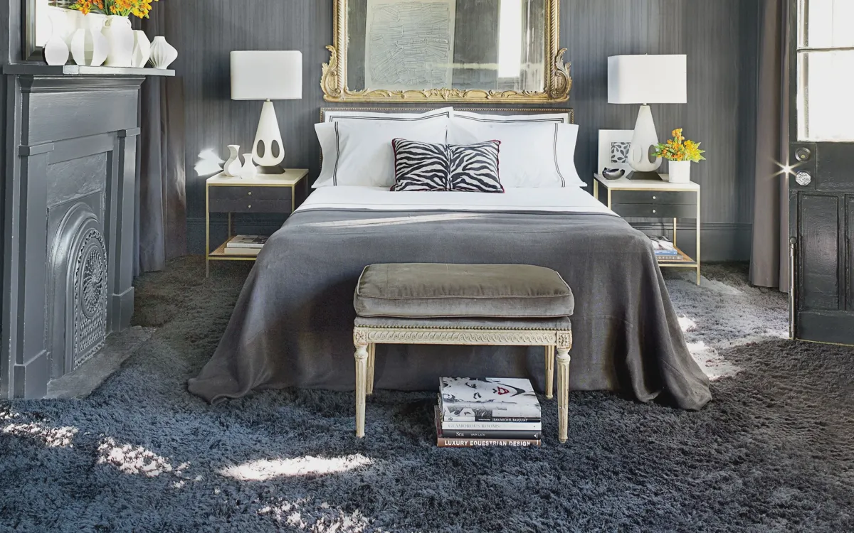 Warm, well-lit bedroom with a neatly made bed encouraging memory foam to soften