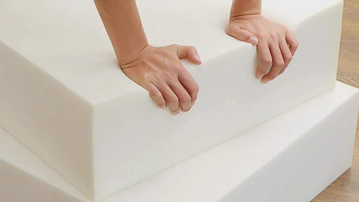 Memory foam mattress laid flat on a work surface being prepared for cutting