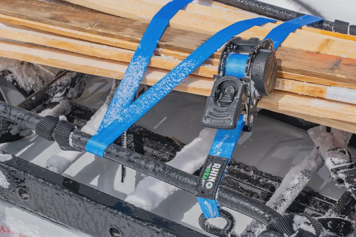 Ratchet straps tied across roof rack crossbars