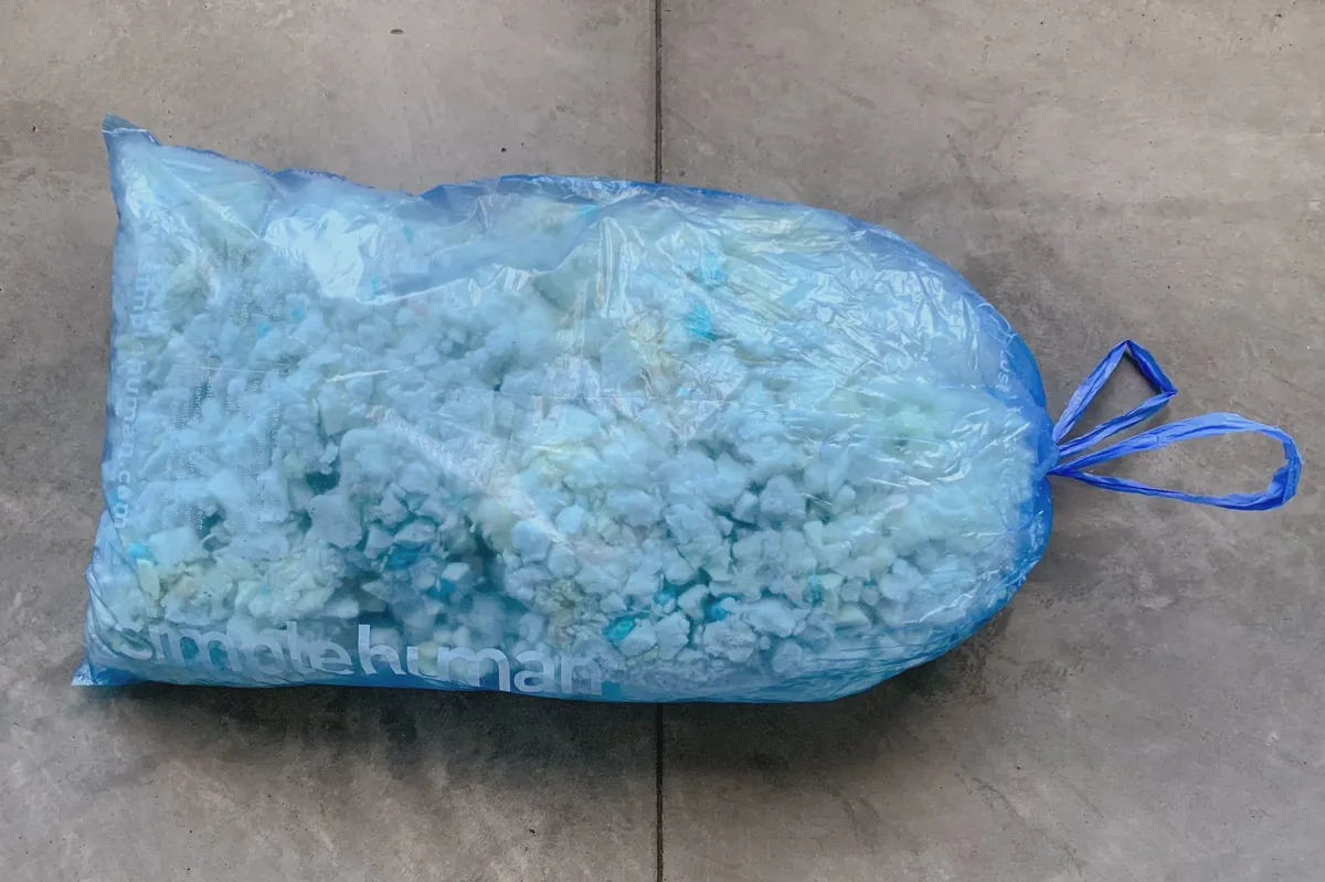 Spot cleaning a memory foam pillow with a damp cloth