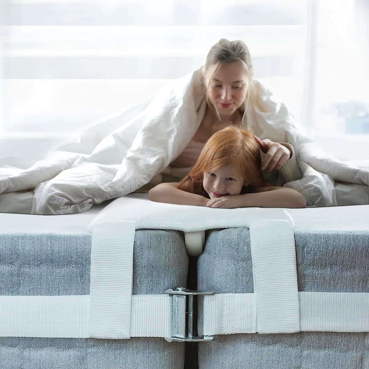Split king mattress connector strap with locking buckle wrapped around two twin XL mattresses