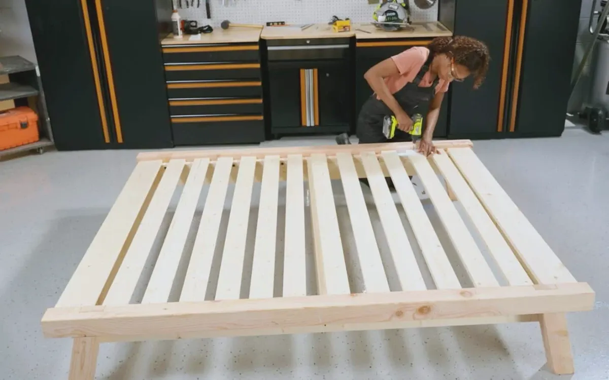 Installing wooden slats on a bed frame with screws