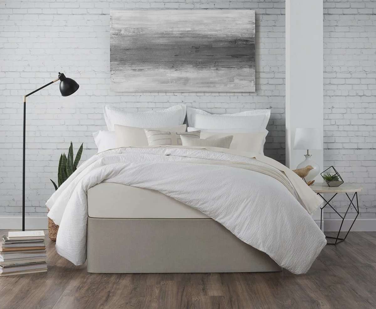 Wrap-around bed skirt installed on an adjustable bed base