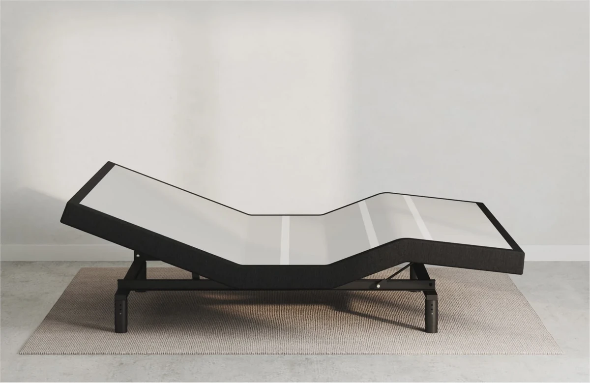 Adjustable bed with a bench placed at the foot to conceal the metal frame