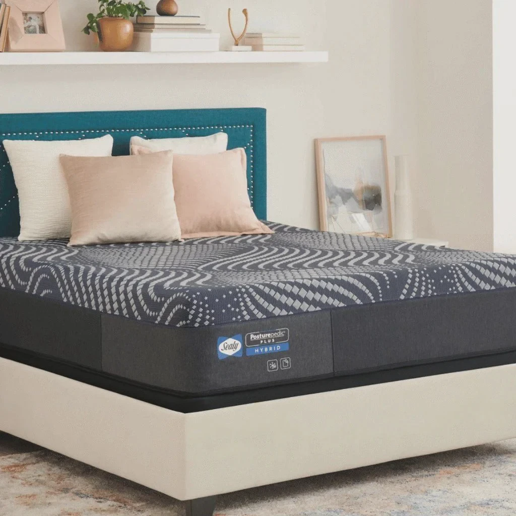 Sealy Posturepedic hybrid mattress shown on a bed frame