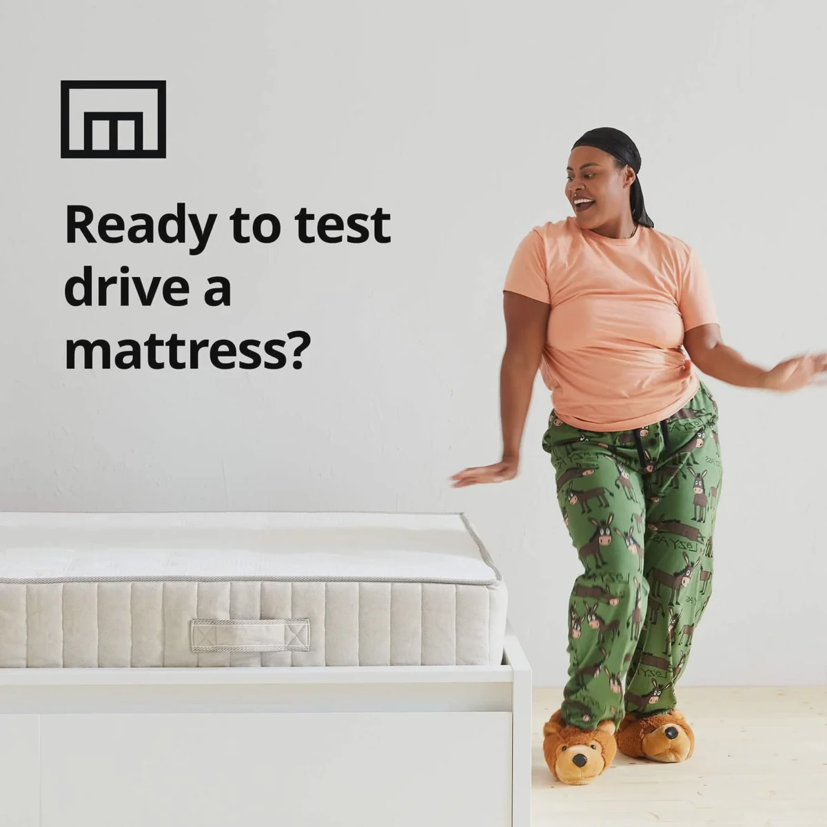 Person dancing in pajamas next to an IKEA mattress box, illustrating the 90-day trial.
