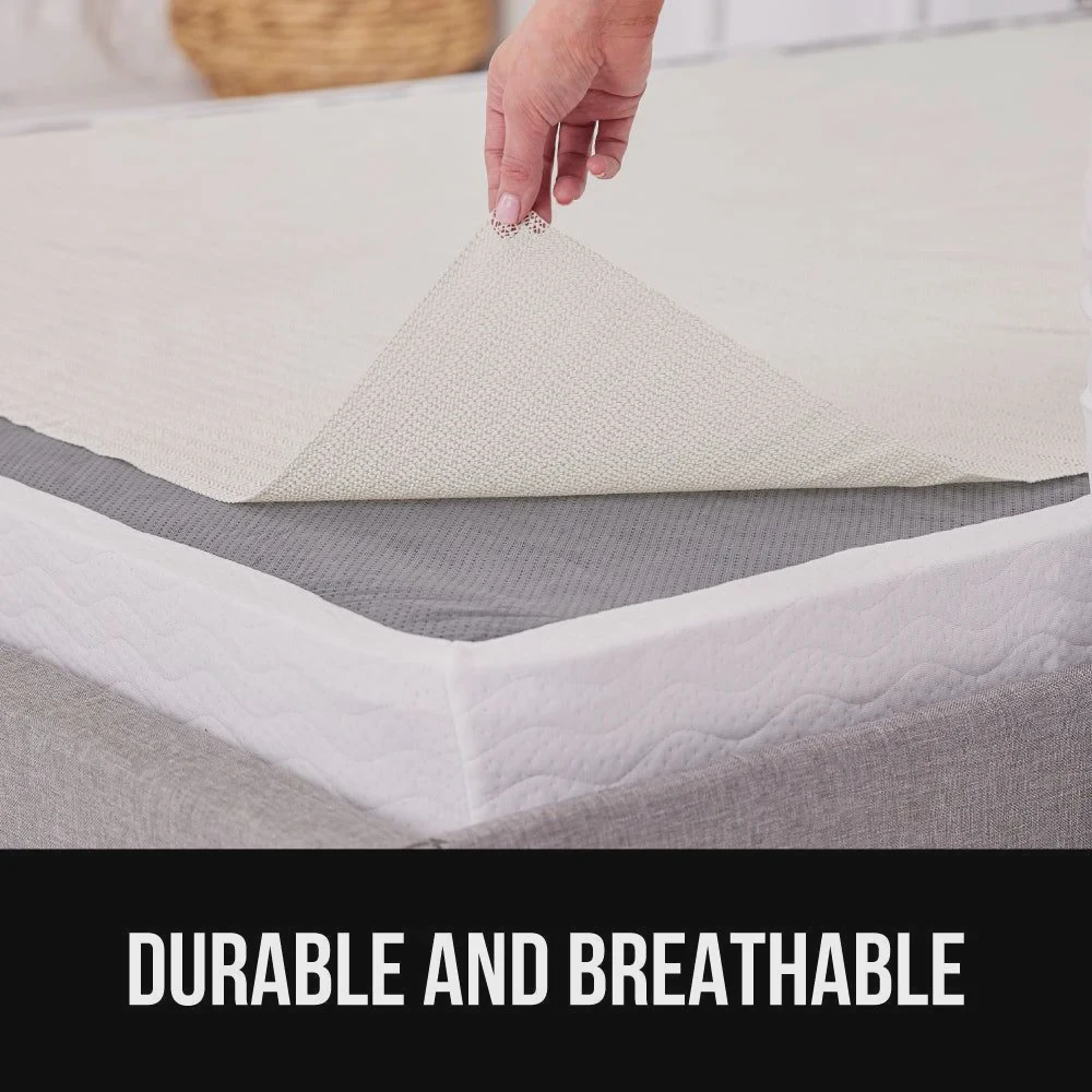Non-slip rubber mattress gripper pad placed between a mattress and bed base