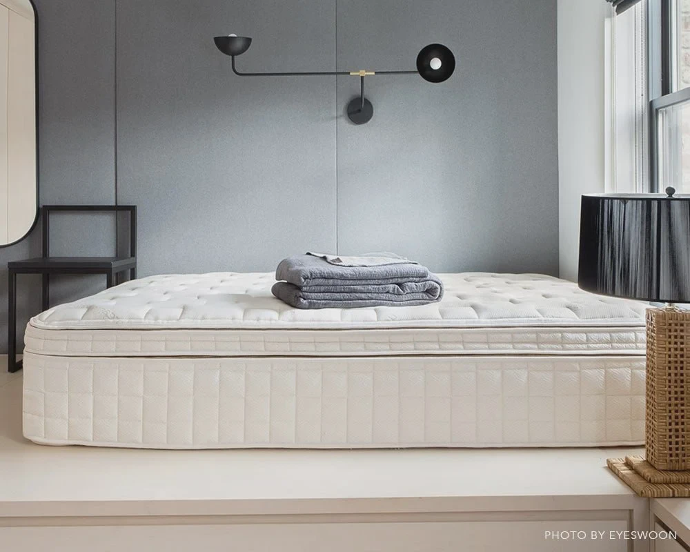 Naturepedic EOS Pillowtop styled in a warm, modern bedroom