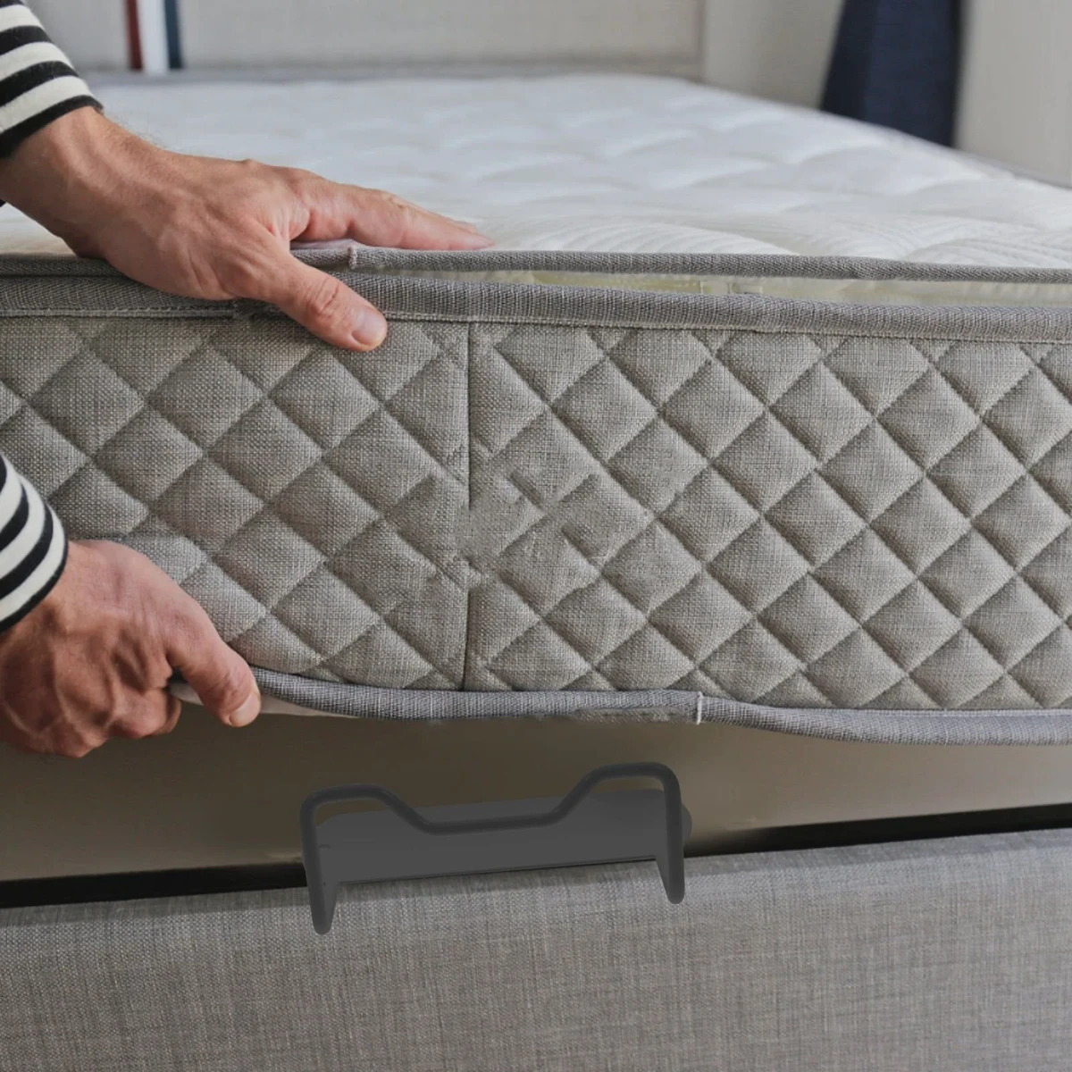 Metal mattress retainer bar clamped to a metal bed frame to stop the mattress from sliding