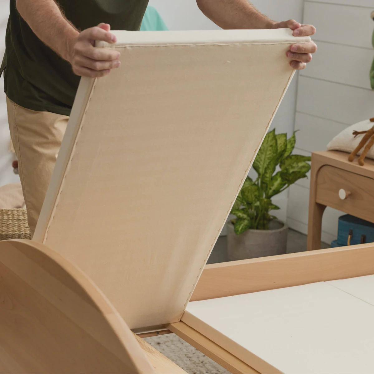 Close-up of a slatted wood bunkie board with fabric cover showing slat spacing