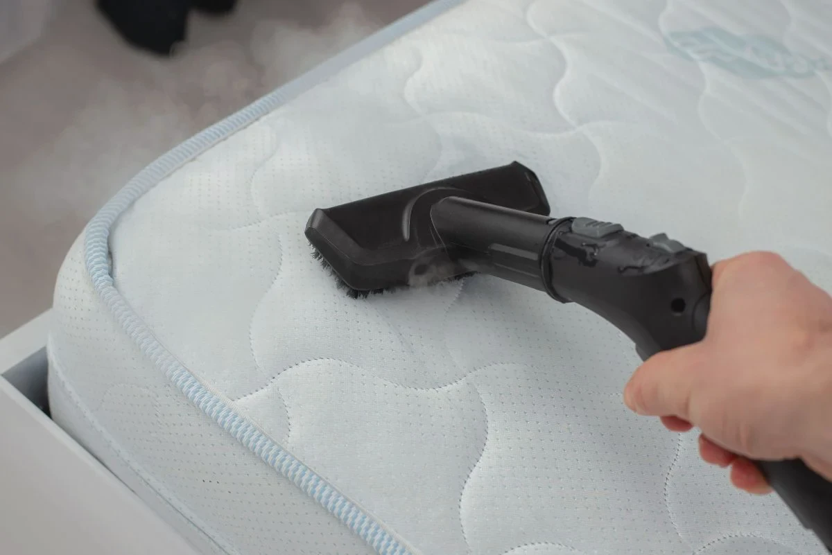 Vacuuming a Zinus memory foam mattress with an upholstery attachment