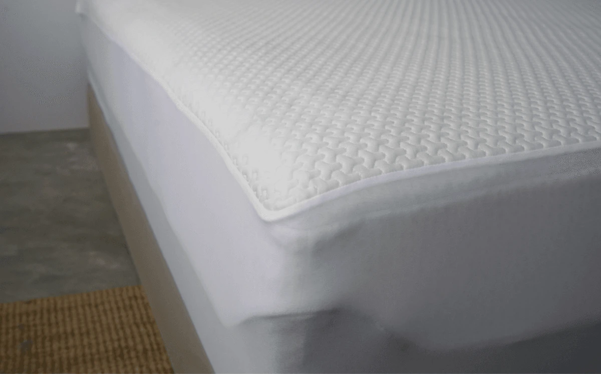 Waterproof mattress protector covering a bed to prevent sweat stains