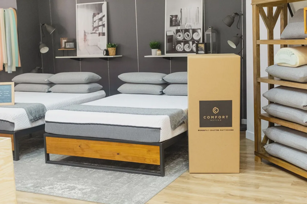 New mattress on a bed frame in a sunlit bedroom