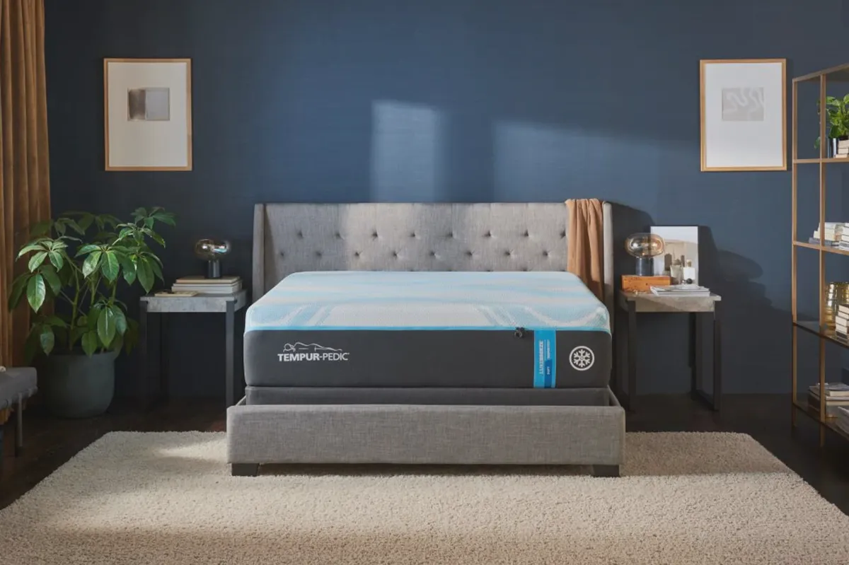 Side profile of a Tempur-Pedic LuxeBreeze memory foam mattress on a platform bed