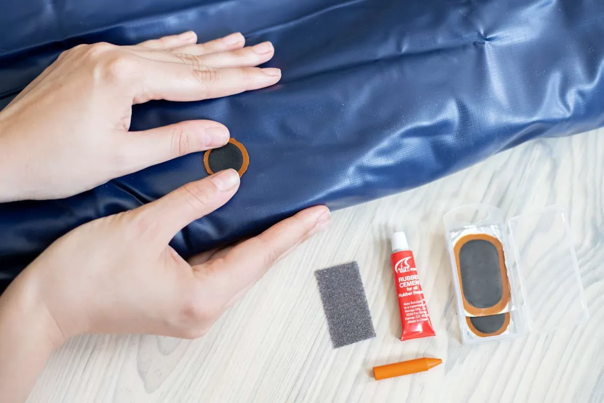 Soapy water being used to find the leak in an air mattress