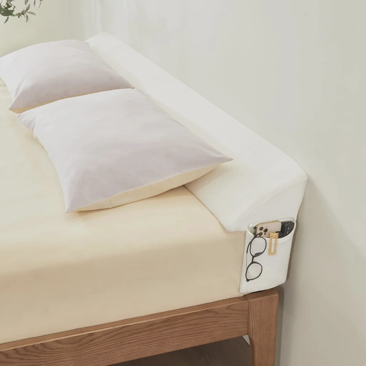 Long triangular bed wedge gap filler that slots between mattress and headboard