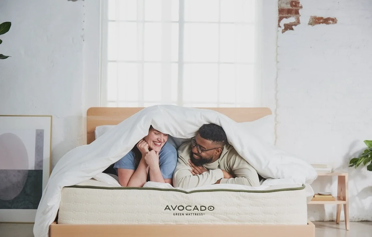 Couple lying on an Avocado Green mattress during the home trial period