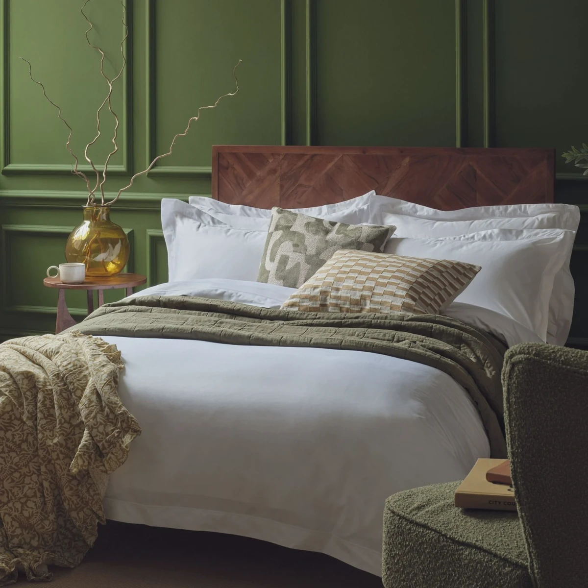 Crisp white cotton flat sheet draped over a neatly made bed