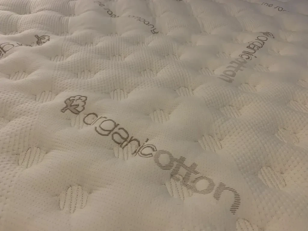 Saatva mattress cutaway showing organic cotton cover over individually wrapped coils