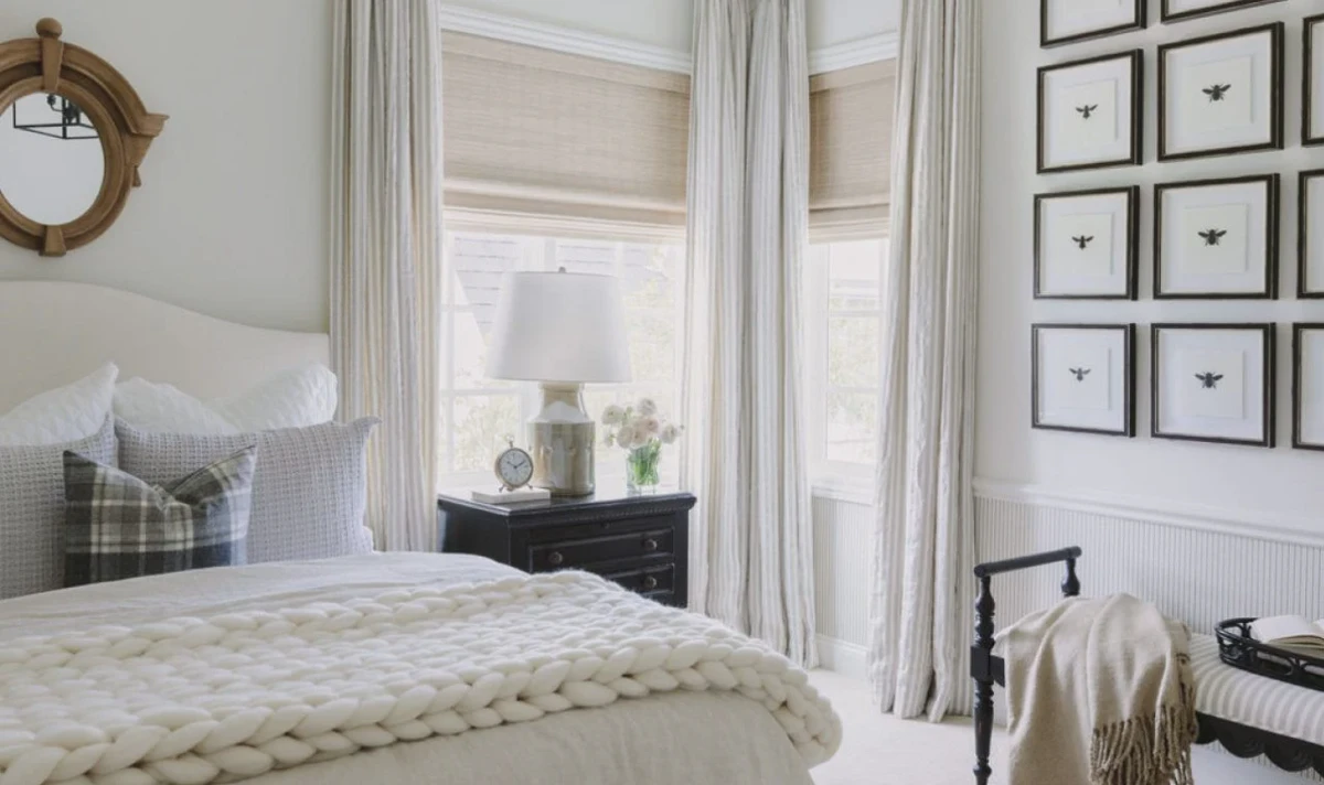 Bedroom with proportional nightstand lamps flanking a tall upholstered headboard