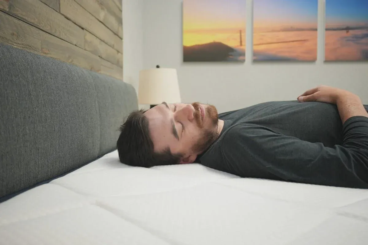 Tester lying on a Lull Original Premium mattress as a back sleeper