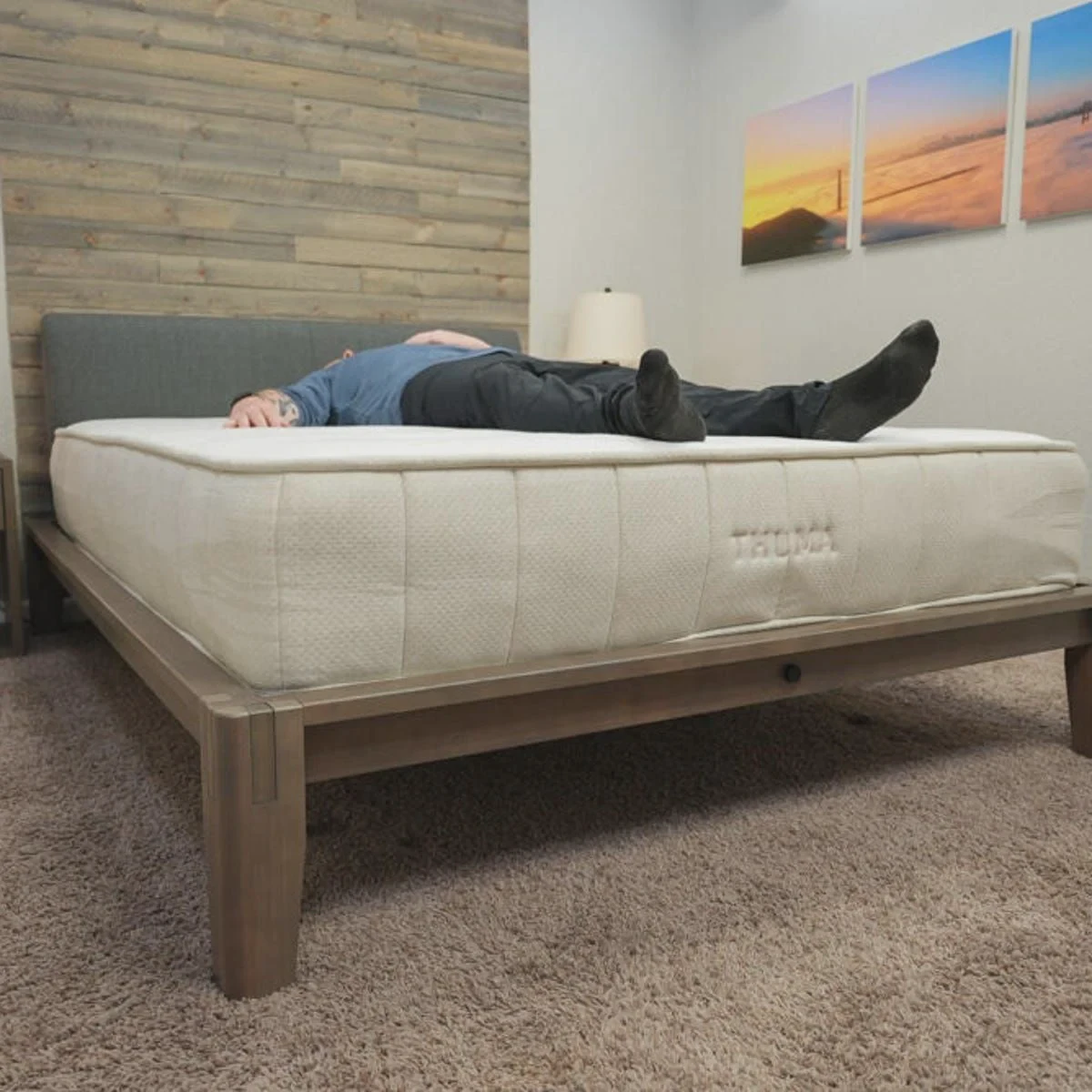 Tester evaluating the Thuma mattress in the back-sleeping position
