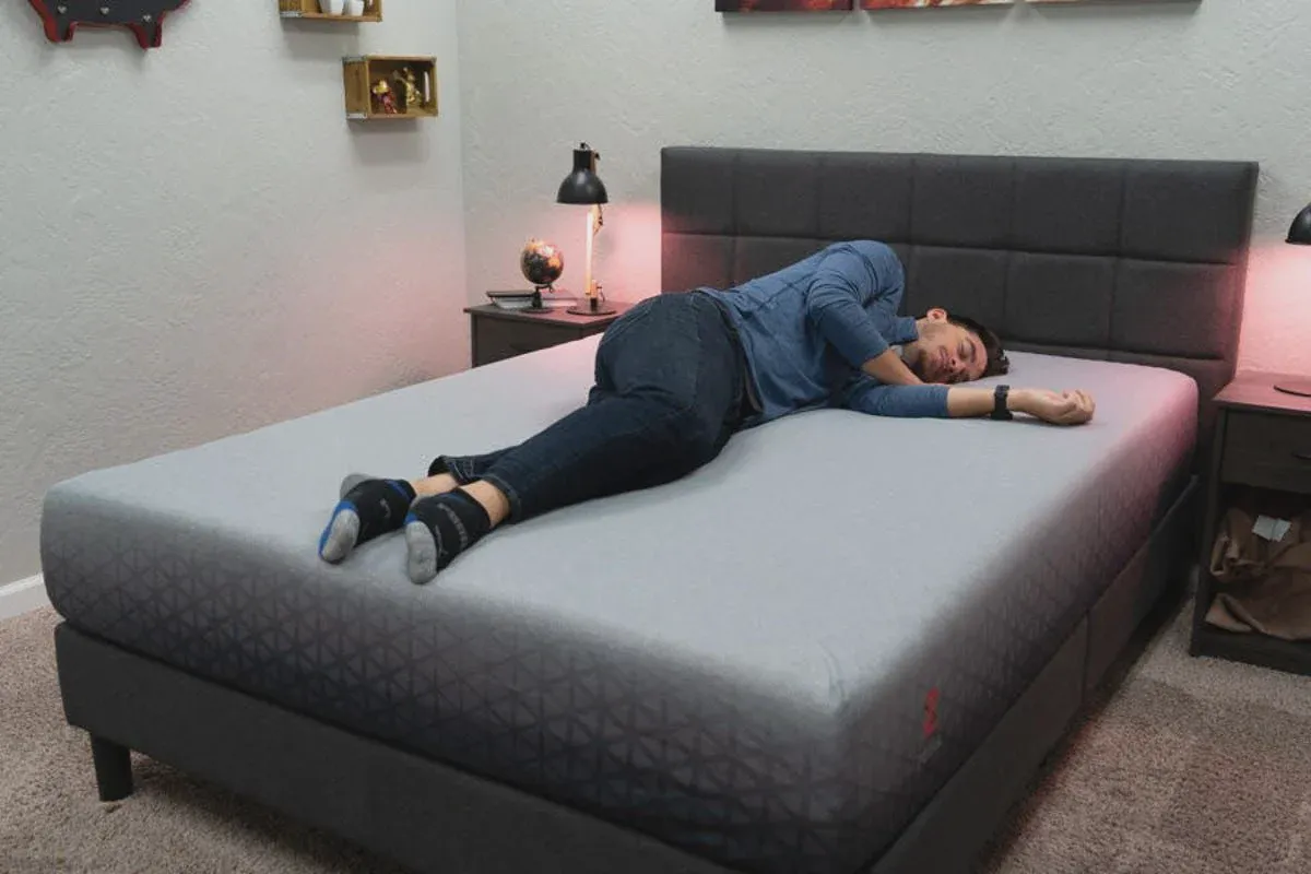 Side sleeper testing the Zoma mattress for pressure relief at the shoulders and hips