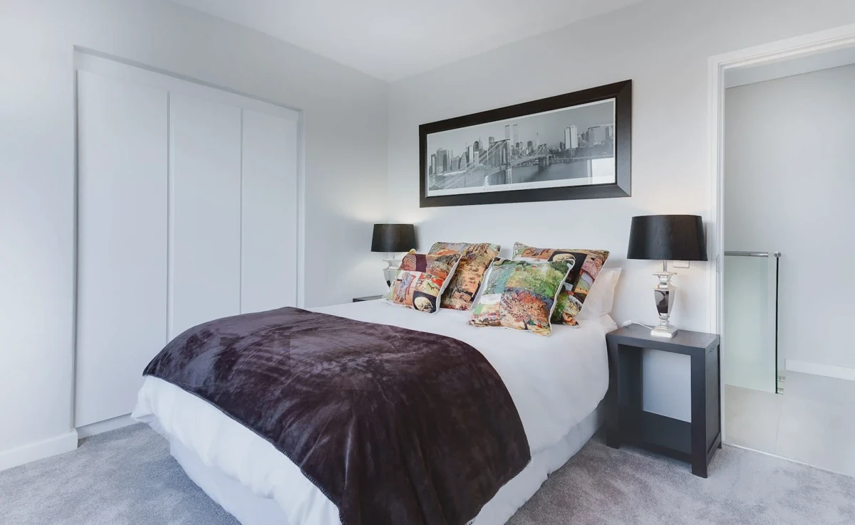 Low profile box spring under a modern mattress in a minimalist bedroom