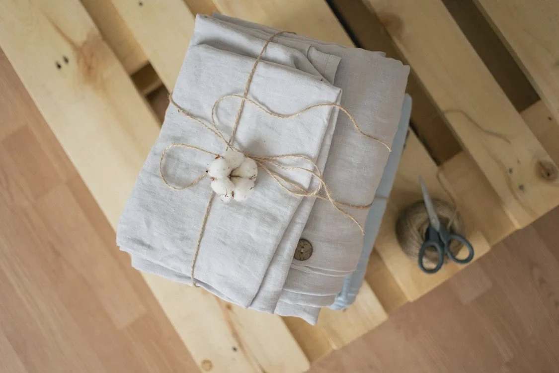 Linen garments hanging to air dry on a wooden rack