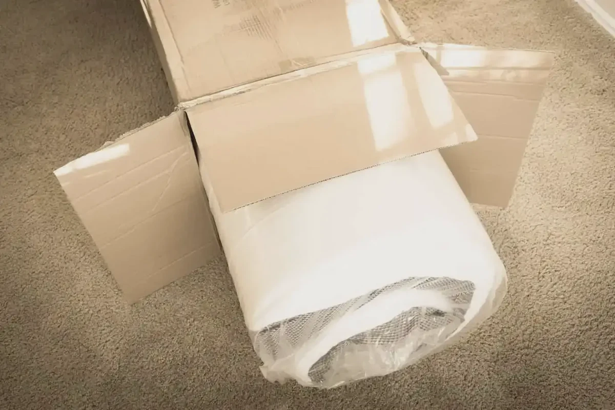 Memory foam mattress rolled and compressed using a vacuum bag